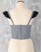 水玉とギンガム柄を組み合わせたビスチェのバックスタイル。肩には黒のフリル。