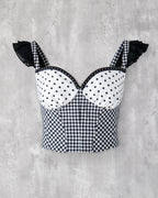 水玉とギンガム柄を組み合わせたビスチェ。肩に黒のフリル、胸元にはスタッズブレードのアクセント。