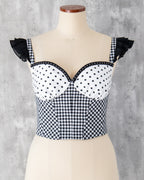 水玉とギンガム柄を組み合わせたビスチェ。肩に黒のフリル、胸元にはスタッズブレードのアクセント。