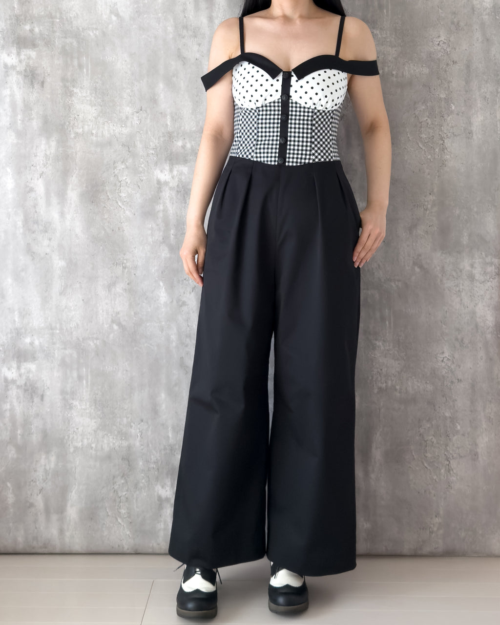 Model wearing the Amy Jumpsuit, polka dot and gingham check with off-shoulder collar. Front view — Atë