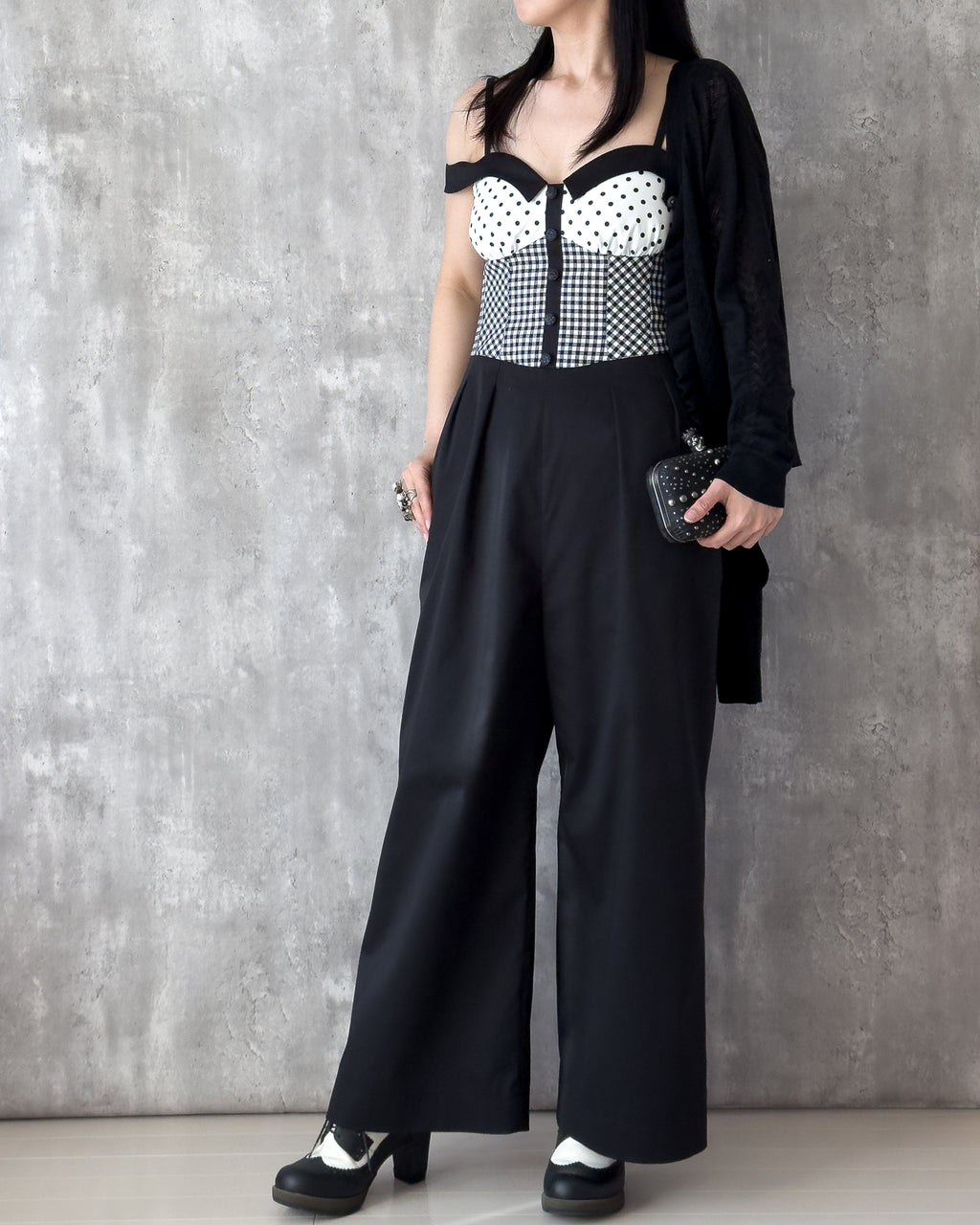 Model wearing the Amy Jumpsuit, polka dot and gingham check with off-shoulder collar. Styling idea — Atë