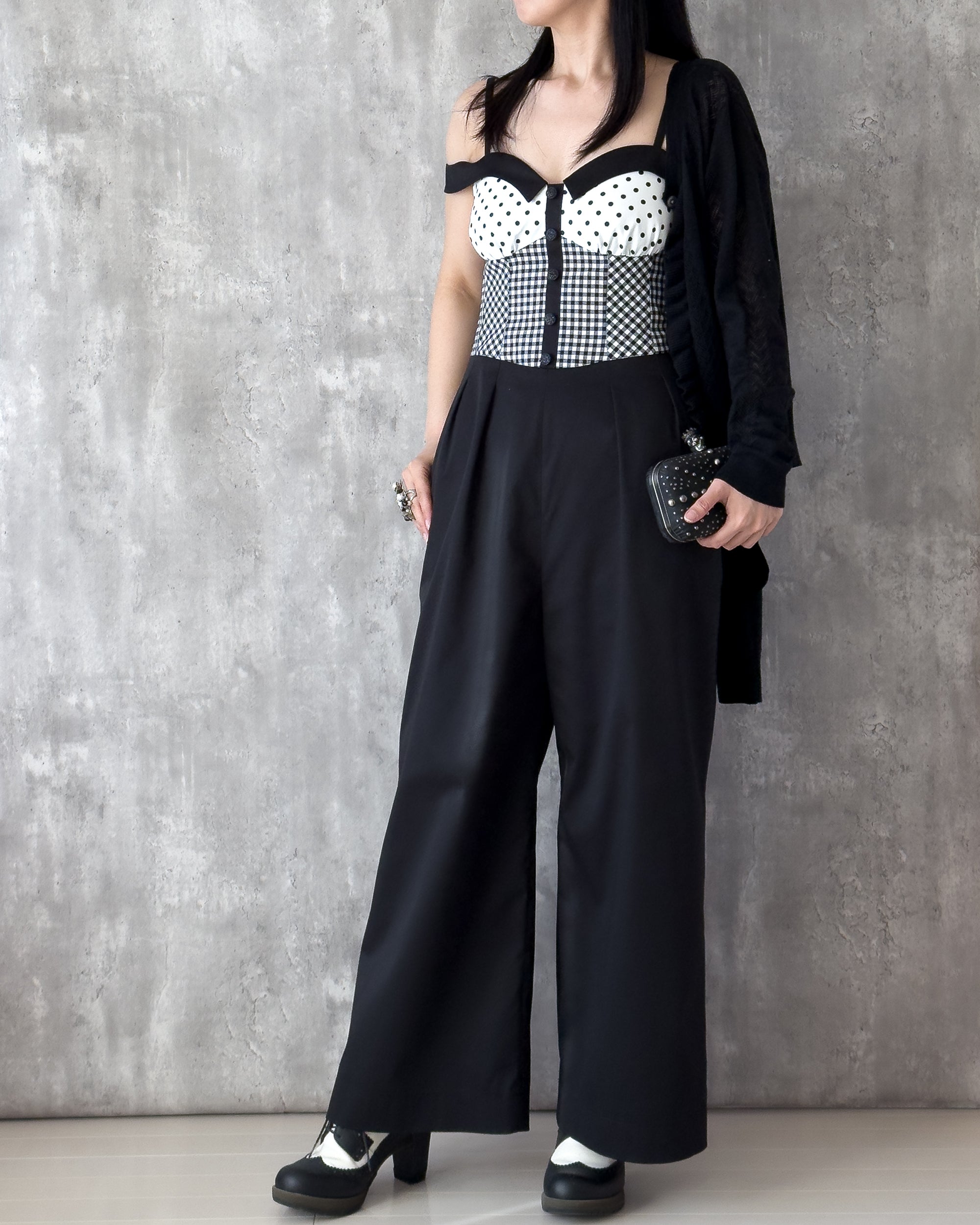 Model wearing the Amy Jumpsuit, polka dot and gingham check with off-shoulder collar. Styling idea — Atë