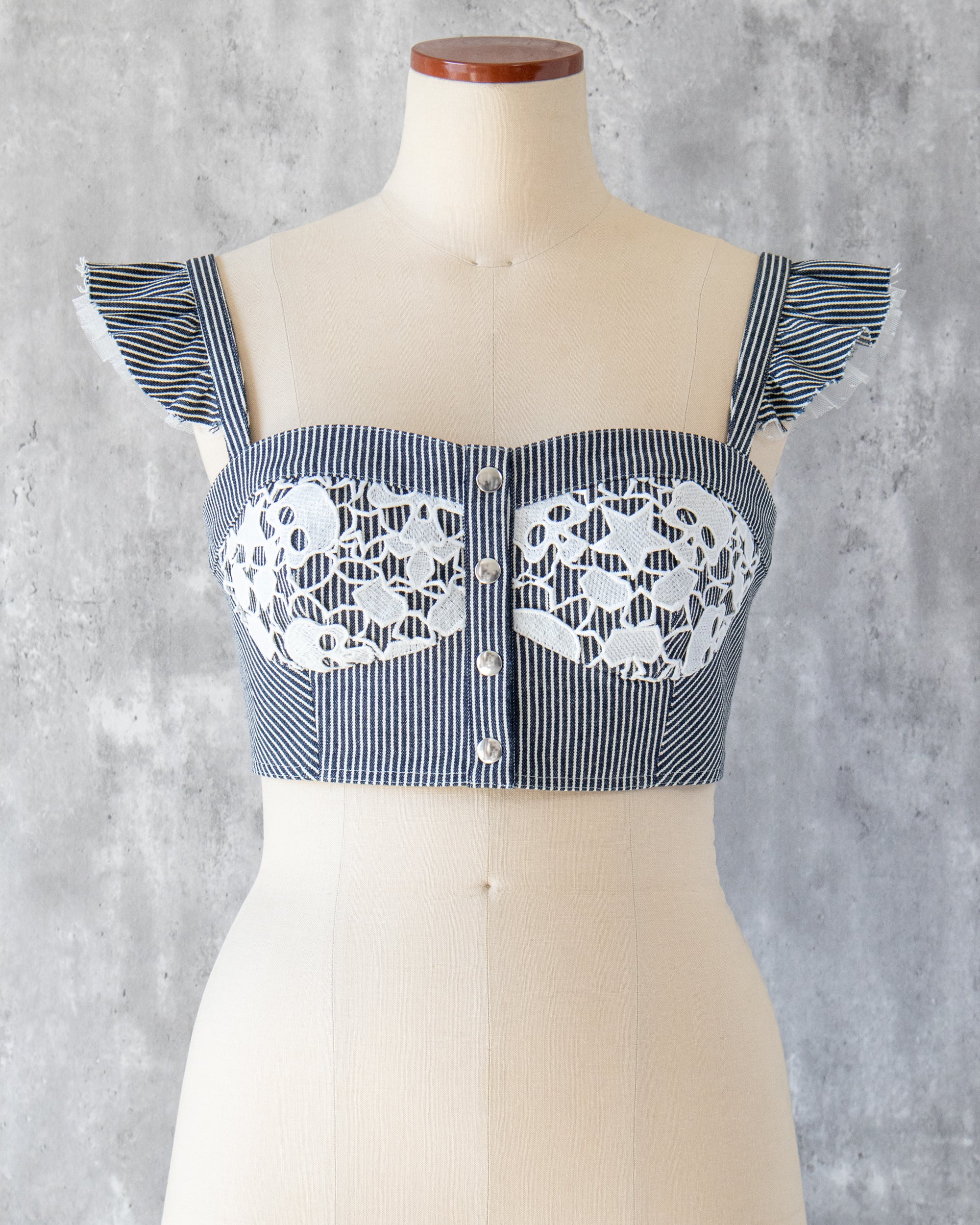 Carla Bustier in indigo hickory denim — front view, skull-motif lace