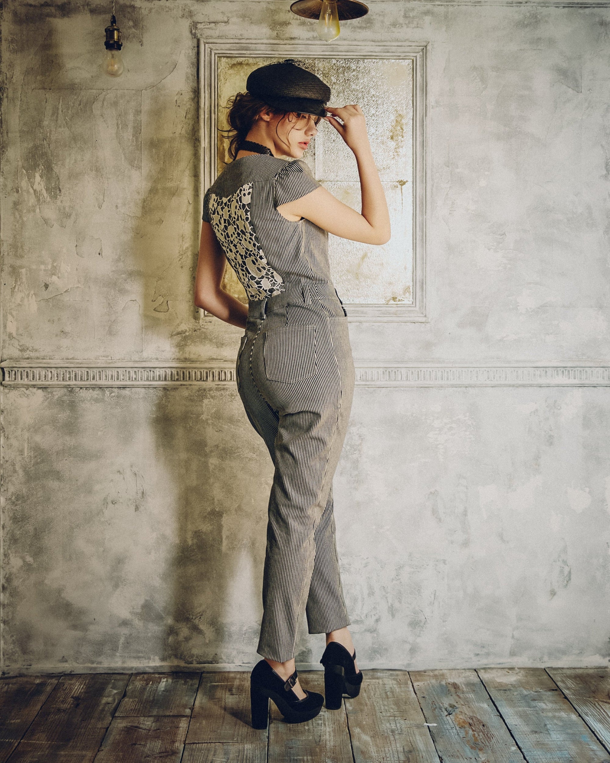 Model wearing Carla Jumpsuit in indigo hickory denim — back, Atë