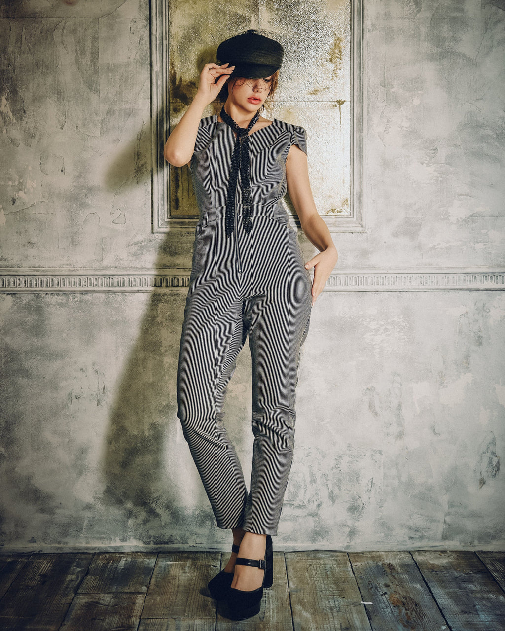 Model wearing Carla Jumpsuit in indigo hickory denim — front, Atë