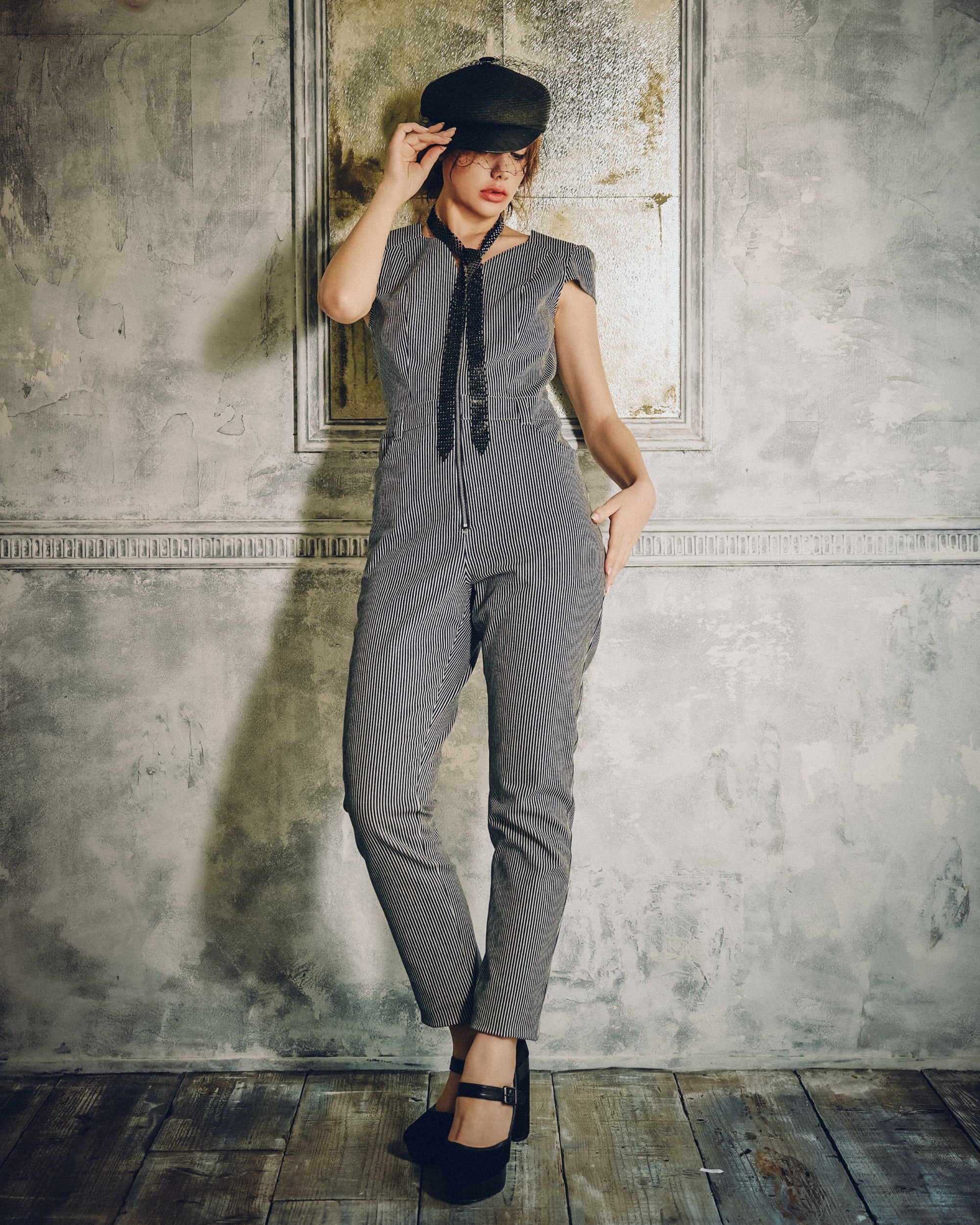 Model wearing Carla Jumpsuit in indigo hickory denim — front, Atë