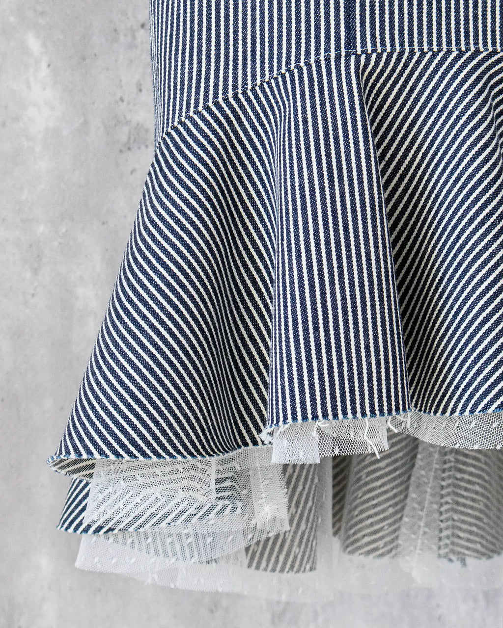 Frill hem detail in hickory denim and dot tulle — Carla Skirt by Atë