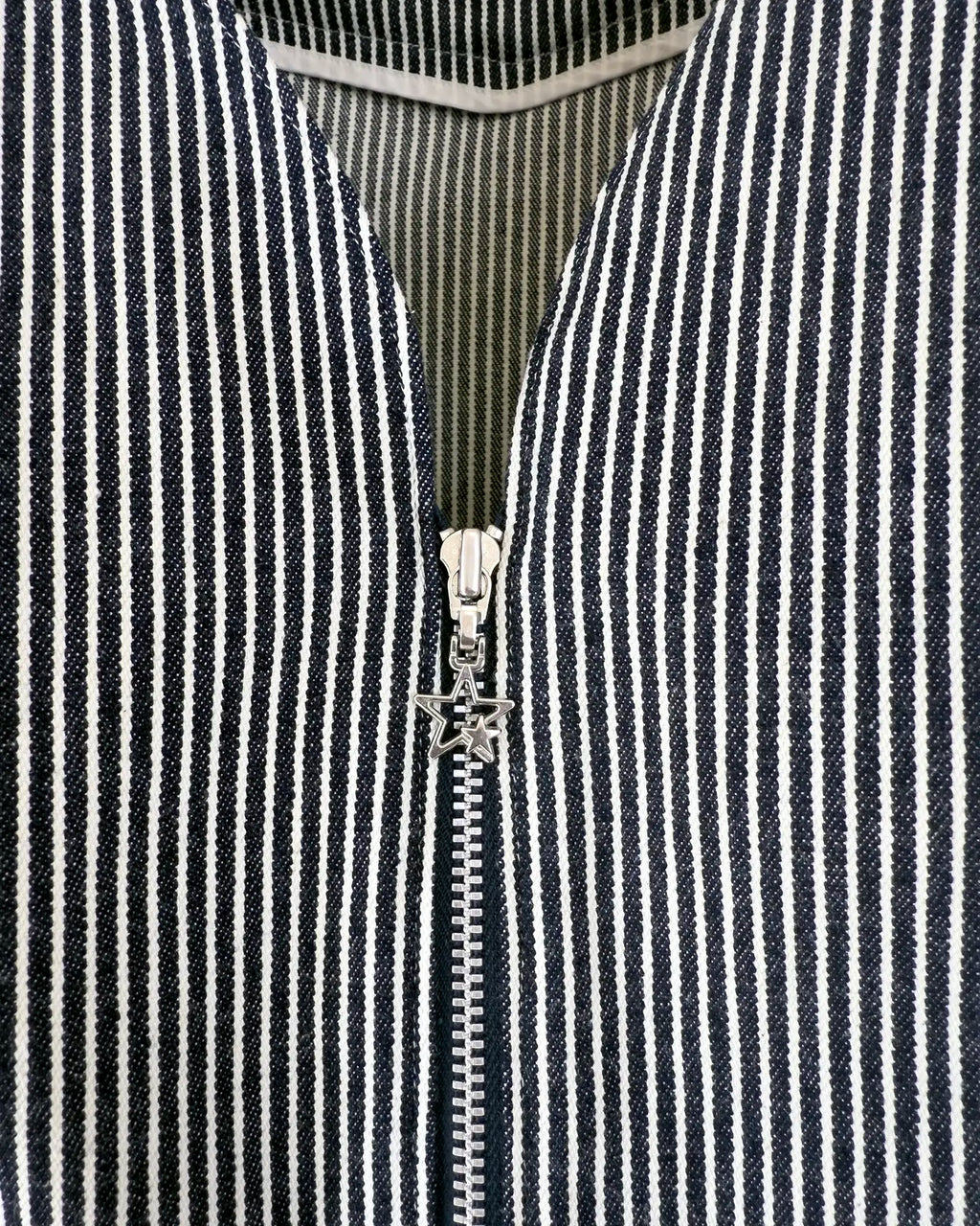 Zip-front detail with star charm in hickory stripe denim — Carla Jumpsuit by Atë