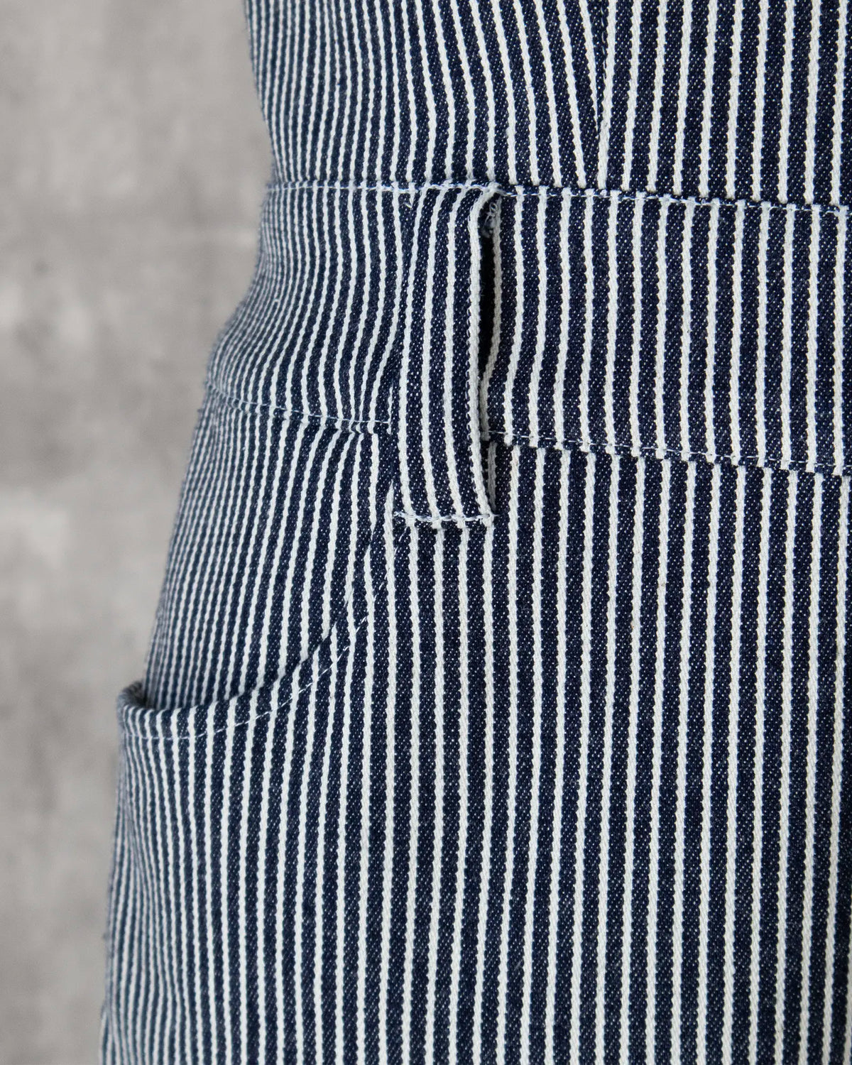 Pocket and waist belt detail in hickory stripe denim — Carla Jumpsuit by Atë