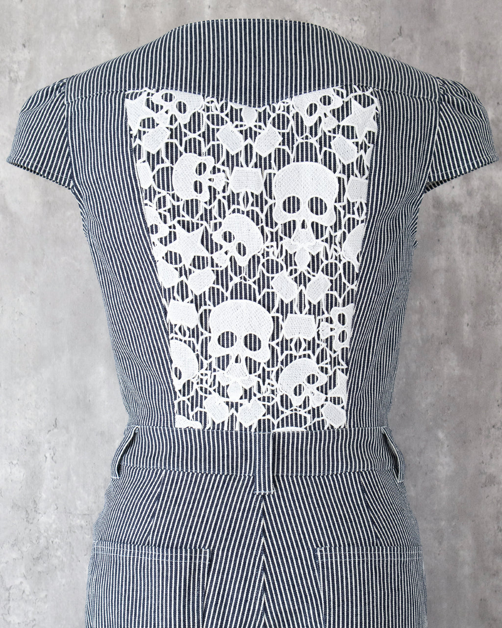 Carla Jumpsuit in indigo hickory denim — detail of white skull-motif lace on the back