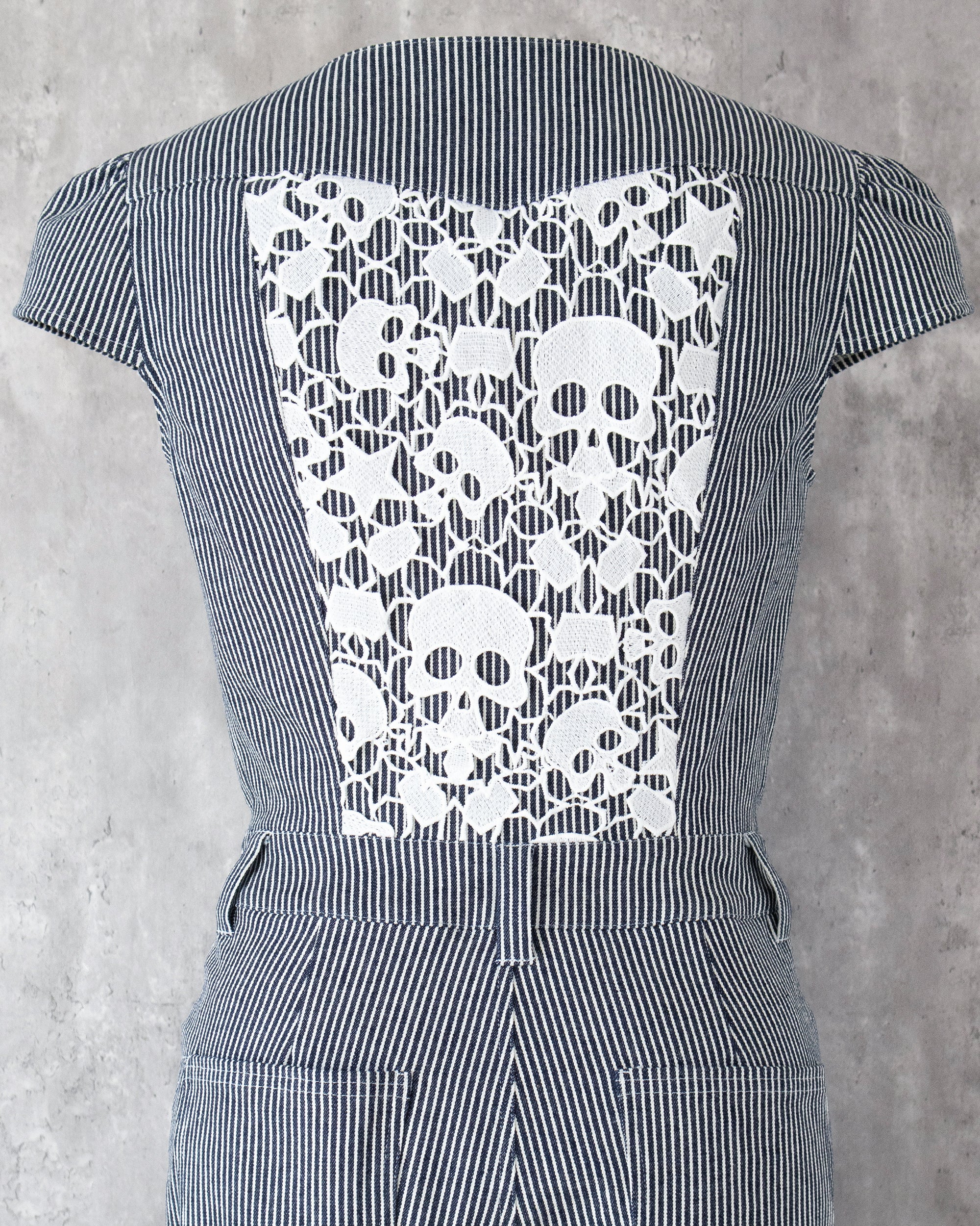 Carla Jumpsuit in indigo hickory denim — detail of white skull-motif lace on the back