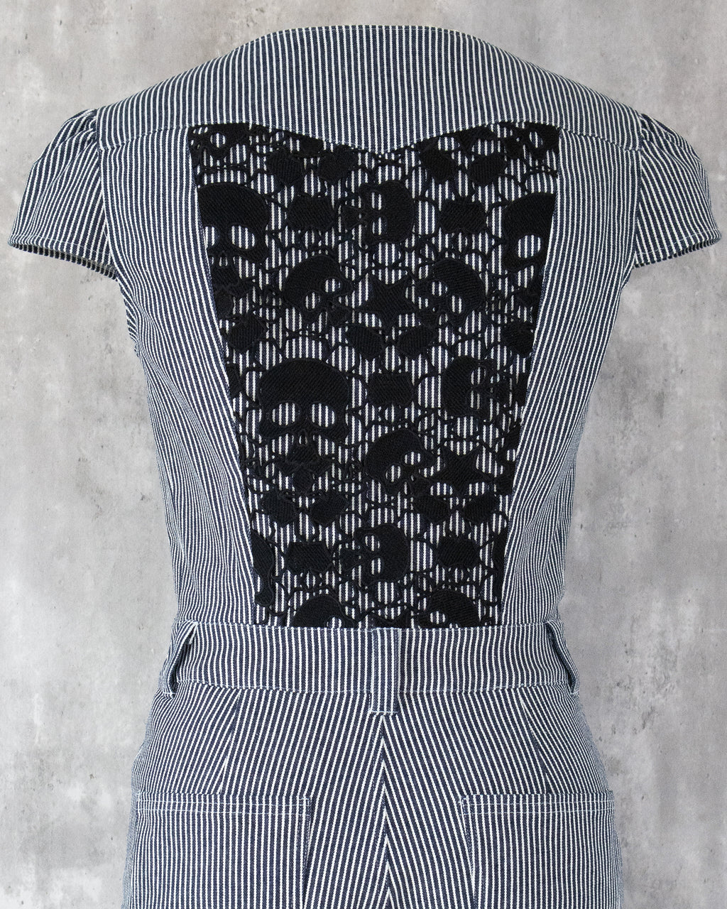 Carla Jumpsuit in indigo hickory denim — detail of black skull-motif lace on the back
