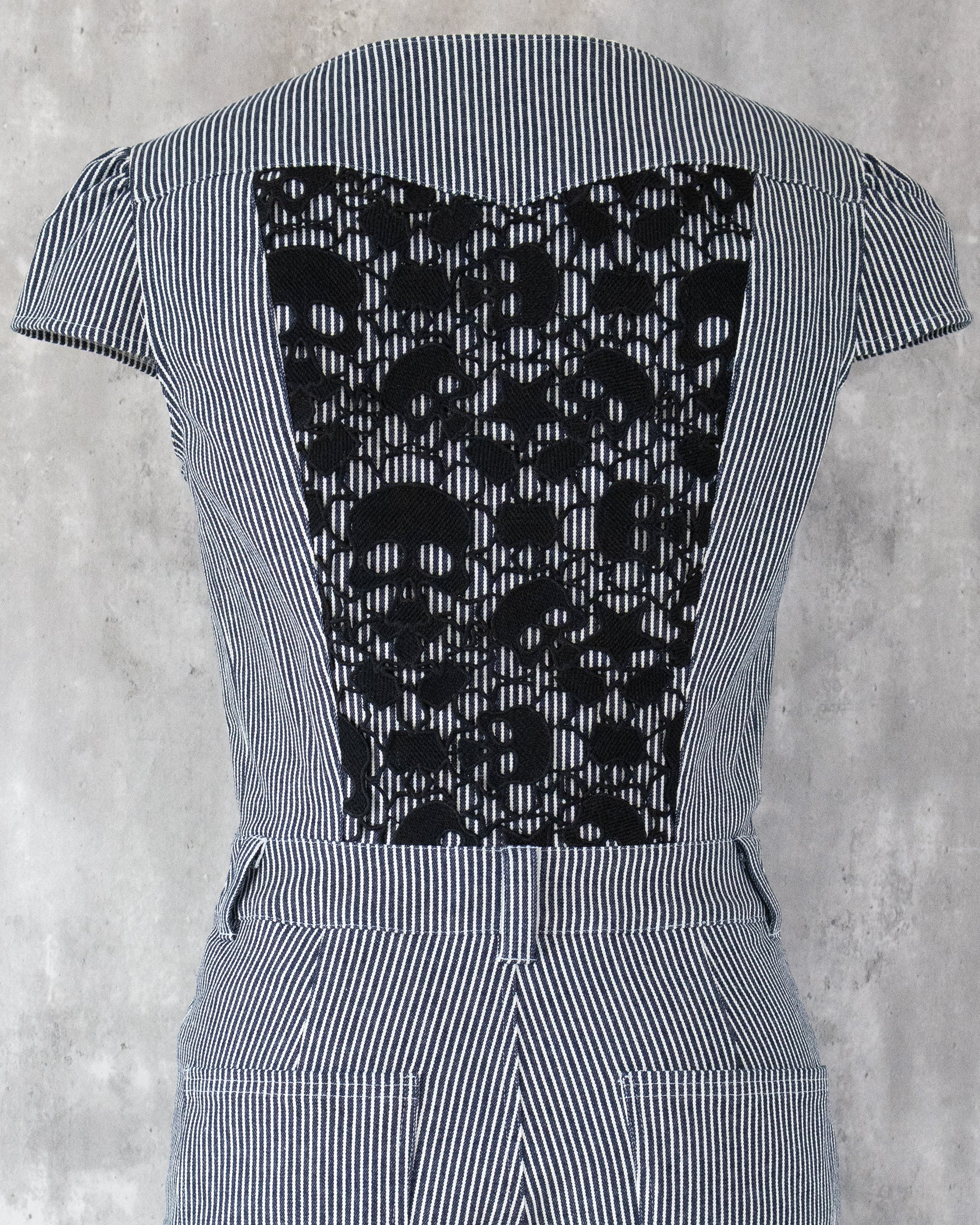 Carla Jumpsuit in indigo hickory denim — detail of black skull-motif lace on the back